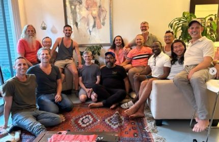 Group of gay men, Trevor James' clients, smiling after a bodywork session. Satisfaction with men's bodywork by Trevor James.