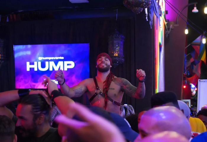 Micky's West Hollywood dancefloor with a shirtless dancer in a harness and bandana. Gay nightlife scene at Micky's, a popular gay bar.