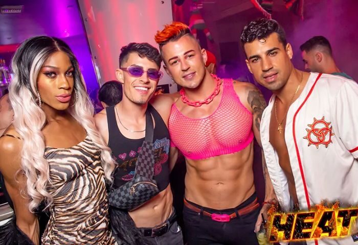 Nightlife at Micky's West Hollywood: A group of stylish people pose at the popular gay bar. Drag queen, crop tops, and party vibes.