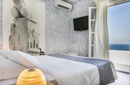 Ilio Maris Gay Hotel room in Mykonos Chora Town: Minimalist design with private balcony, sea view. Gay travel luxury accommodation.