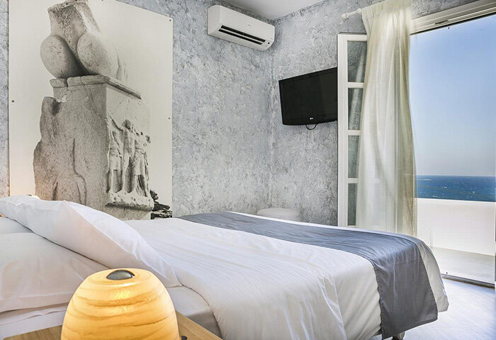 Ilio Maris Gay Hotel room in Mykonos Chora Town: Minimalist design with private balcony, sea view. Gay travel luxury accommodation.