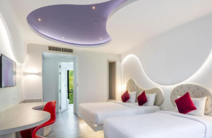 Avatara Resort Koh Samet room. Gay-friendly beachfront hotel with two beds, red accents, and modern design. Ideal for friends' getaway.