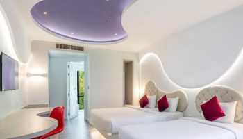 Avatara Resort Koh Samet room. Gay-friendly beachfront hotel with two beds, red accents, and modern design. Ideal for friends' getaway.