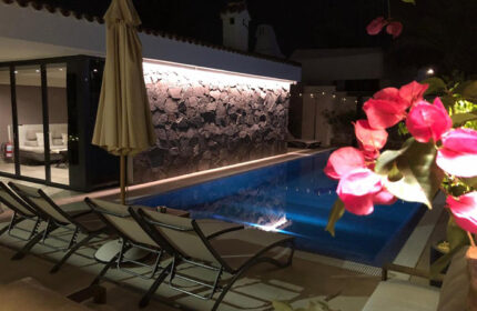 Villa Adler Gay Men Only pool at night. Gran Canaria gay hotel near Yumbo gay nightlife in Playa del Ingles, with lounge chairs.