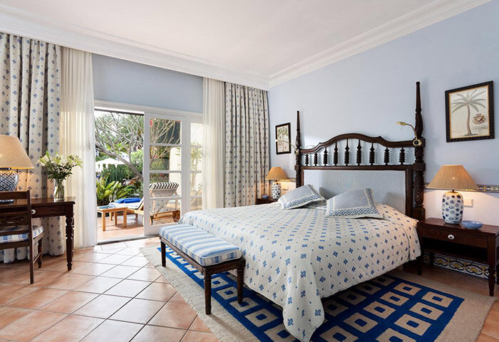 Seaside Grand Hotel Residencia Gran Lujo bedroom. Gay-friendly luxury hotel in Gran Canaria. Patio view, upscale decor, and relaxing ambiance.