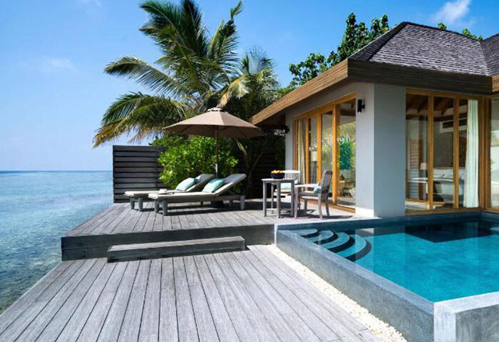 Anantara Veli Maldives Resort overwater bungalow deck with pool, lounge chairs, & ocean view. Gay honeymoon travel destination.