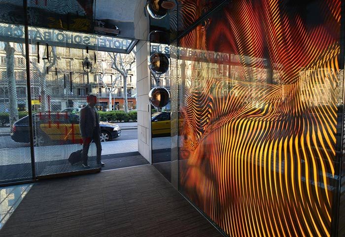 Hotel Soho Barcelona entrance. Most-booked gay hotel in Eixample gayborhood, Barcelona. Man entering, modern design.
