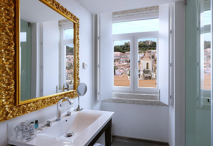 Lisboa Carmo Hotel bathroom with a view of Lisbon. Most booked gay hotel near gay bars and gay saunas in Lisbon. Gay travel advice.