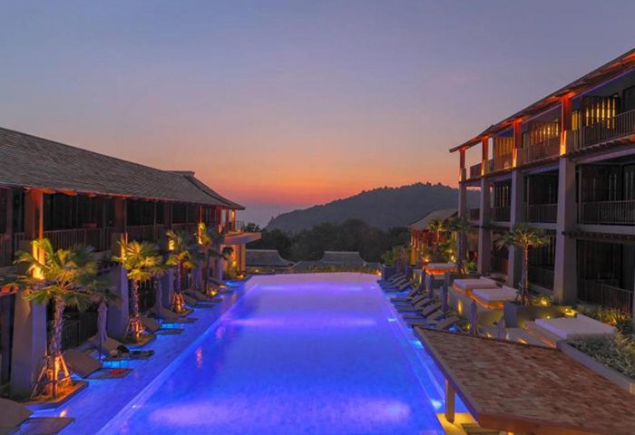 Avista Hideaway Phuket Patong MGallery by Sofitel: Infinity pool view at dusk. Most-booked gay hotel in Phuket. Luxury travel for gay men.