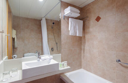 Prima City Hotel Tel Aviv bathroom. Most booked gay hotel by the beach. Sink, mirror, shower, towels. Ideal for 3 people group.