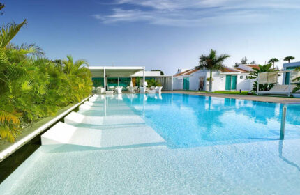 Seven Hotel Wellness: Gay men only hotel pool view. Most booked gay hotel to meet other gay visitors with white lounge chairs.