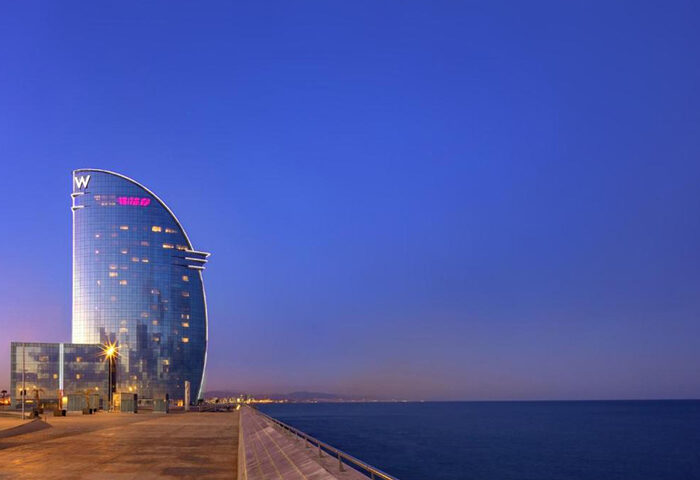 W Barcelona Hotel at dusk. One of the most booked gay-friendly hotels in Barcelona, Spain. Luxury travel destination for gay men.