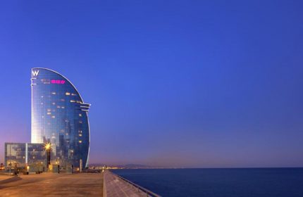 W Barcelona Hotel at dusk. One of the most booked gay-friendly hotels in Barcelona, Spain. Luxury travel destination for gay men.