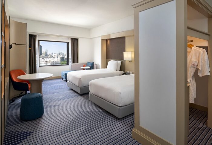 Crowne Plaza Bangkok Lumpini Park hotel room near Silom gay bars. Two beds, city view, closet with robes. One of Bangkok's most booked gay hotels.