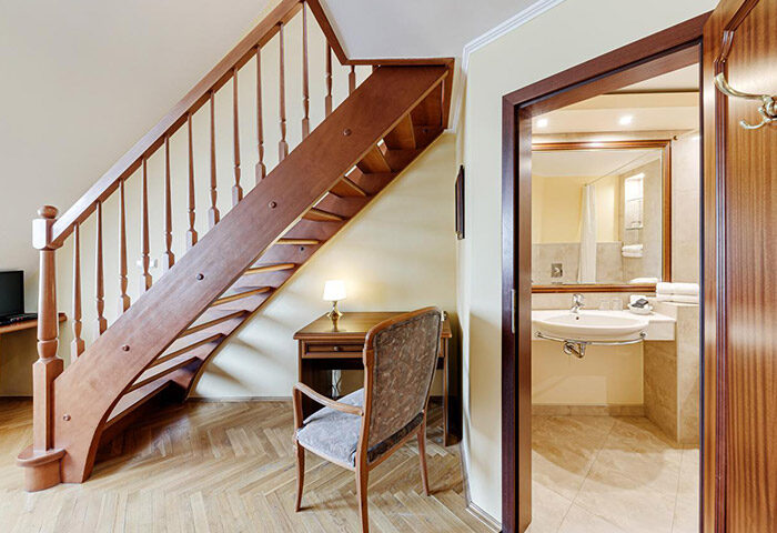 Louren Hotel, Prague. Interior view of a room at this most-booked gay hotel in Vinohrady, for gay groups. Wooden staircase and bathroom.