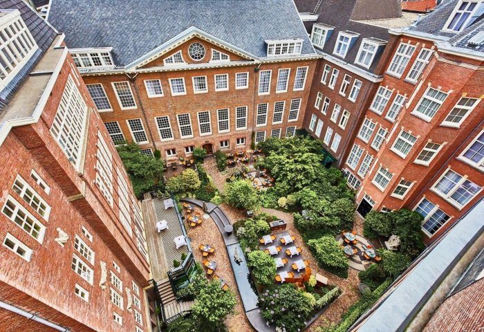 Sofitel Legend The Grand Amsterdam canal view. Gay luxury hotel with courtyard restaurant. Most booked hotels in Amsterdam for gay men.