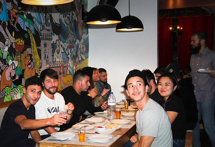Gay party hostel in Lisbon. Group of diverse young adults at Yes! Lisbon Hostel, a most-booked city center hostel, enjoying a meal.