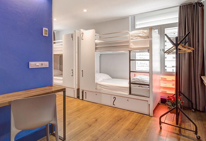 Generator Barcelona gay-friendly party hotel room. Bunk beds, minimalist design, wooden floors. Ideal for gay travelers in Barcelona.