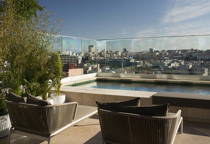 Memmo Principe Real Design Hotel's rooftop pool in Lisbon. Luxury gay hotel with city views, perfect for gay men's travel.