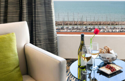 Luxury Carlton Tel Aviv Hotel room with wine, cheese, and ocean view. Most-booked gay hotel near Hilton Beachfront with rooftop pool.