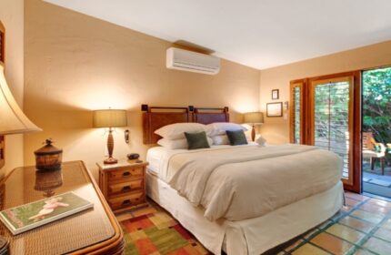 Bedroom at The Hacienda, a luxury gay resort in Palm Springs. King bed, desert decor, and patio access. Perfect for gay men's travel.