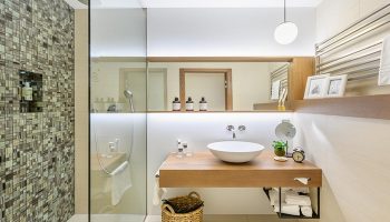 Mosaic House Design Hotel bathroom. Modern design with mosaic shower, wood vanity, and round sink. Gay hotel in Prague Old Town.