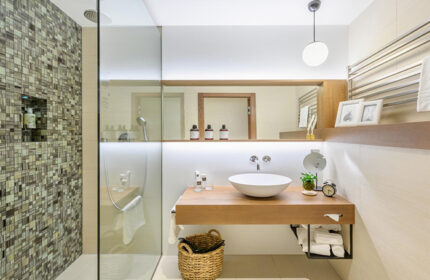 Mosaic House Design Hotel bathroom. Modern design with mosaic shower, wood vanity, and round sink. Gay hotel in Prague Old Town.