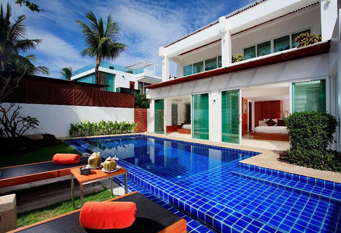 La Flora Resort Patong private pool villa. Gay hotel in Phuket with pool, sunbeds, and access to a bedroom. Tropical vacation.