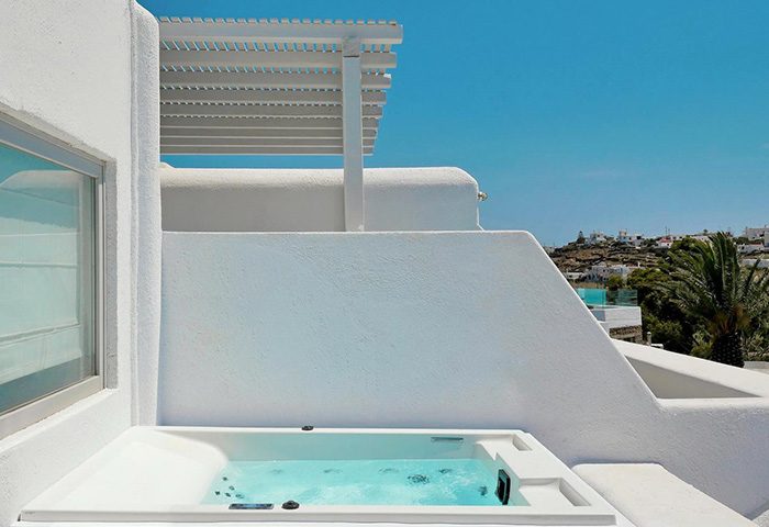 Andronikos Hotel Mykonos: Stylish gay hotel with private balcony and jacuzzi. White architecture, blue sky, and a relaxing vibe. Perfect for gay travel.