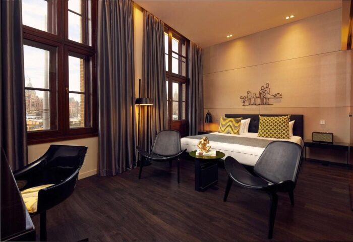 art'otel Amsterdam room. Most popular gay hotel in Amsterdam city center near Central Station. Modern design with chairs and bed.