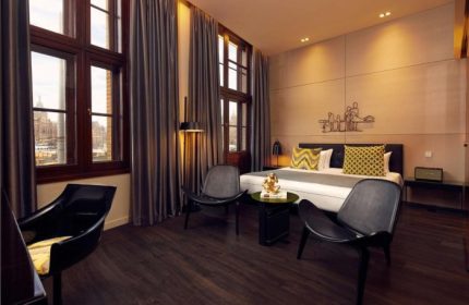 art'otel Amsterdam room. Most popular gay hotel in Amsterdam city center near Central Station. Modern design with chairs and bed.