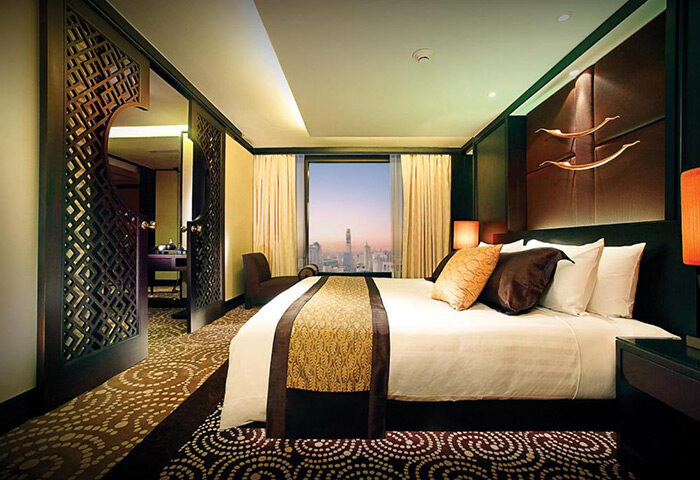 Gay-popular Banyan Tree Bangkok hotel room near Silom's gay bars. Luxury bedroom with city view. Best gay-friendly hotel in Bangkok, Thailand.