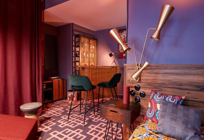 25hours Hotel Terminus Nord room: bar, bed, & retro lamps. Instagrammable design near Paris gay nightlife. Stylish, unique interior.