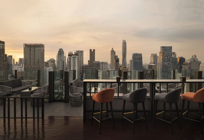 Hotel Indigo Bangkok Wireless Road rooftop bar view. Instagram-perfect spot for gay travelers. Cityscape panorama from a stylish, modern bar.