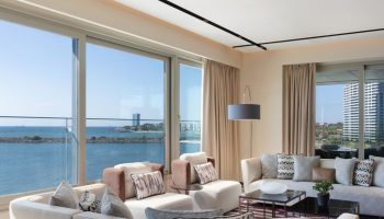 Luxury JW Marriott Hotel Istanbul Marmara Sea beachfront suite. Upscale gay hotel with sea view. Modern interior design, perfect for gay travel.