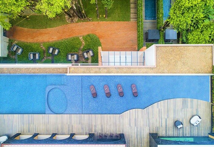 Aerial view of X2 Chiang Mai Riverside Resort, a popular luxury hotel choice for gay travelers. Pool, garden, and lounge areas visible.