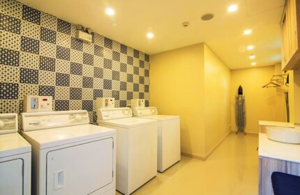 Holiday Inn Express Krabi Ao Nang Beach laundry room. Washers, dryer, ironing board. Popular gay backpacker hotel.