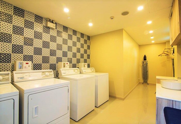 Holiday Inn Express Krabi Ao Nang Beach laundry room. Washers, dryer, ironing board. Popular gay backpacker hotel.