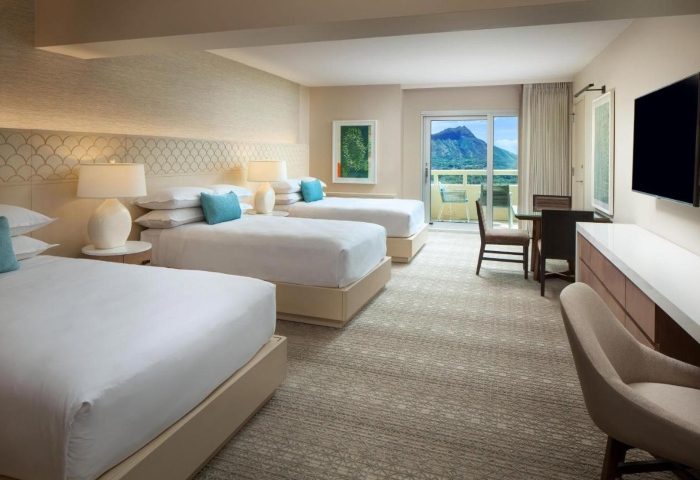 Sheraton Waikiki Beach Resort room with three beds, balcony, and mountain view. Popular gay beachfront hotel for gay groups.