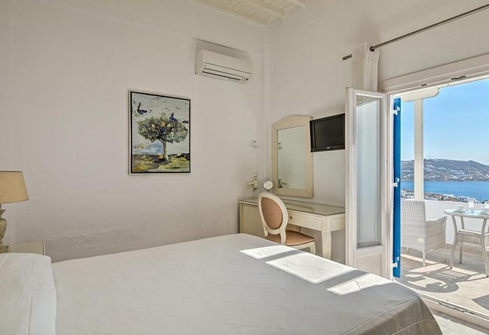 Hotel Alkyon, Mykonos Town: Room interior with a bed, desk, and balcony overlooking the sea. Popular gay honeymoon destination.