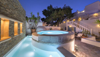 Carbonaki Hotel, Mykonos: Pool and hot tub at dusk. Popular gay hotel in Mykonos Town for gay travelers. Relaxing Greek island vacation.