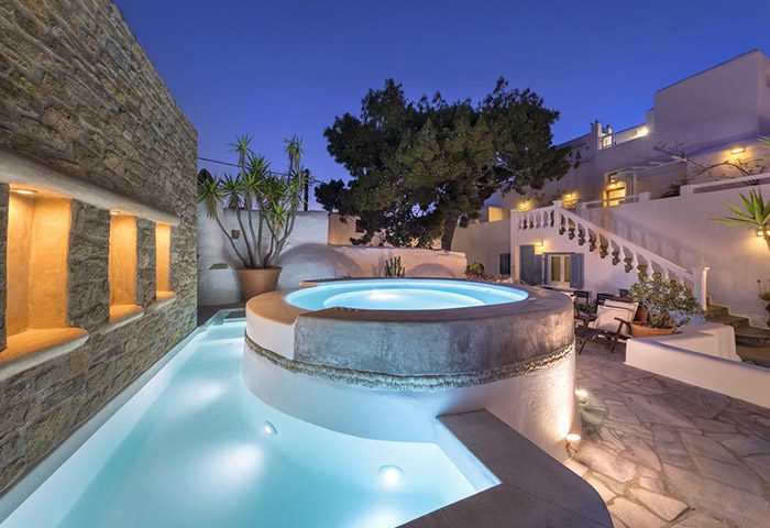 Carbonaki Hotel, Mykonos: Pool and hot tub at dusk. Popular gay hotel in Mykonos Town for gay travelers. Relaxing Greek island vacation.