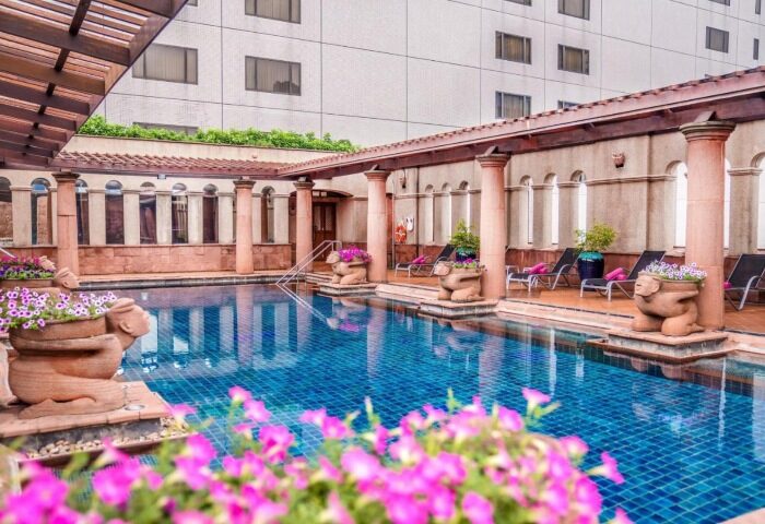 Crowne Plaza Bangkok Lumpini Park pool. Gay-friendly hotel near Silom Soi 2. Relaxing pool area with lounge chairs. Bangkok hotel.