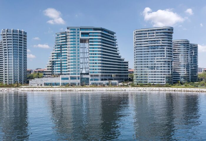 JW Marriott Hotel Istanbul Marmara Sea beachfront view. Luxury hotel perfect for gay travel. Modern architecture reflecting in the water.