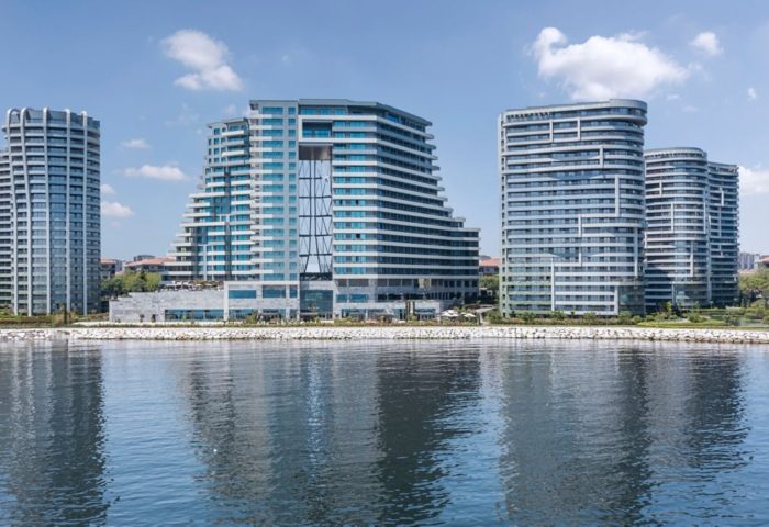 JW Marriott Hotel Istanbul Marmara Sea beachfront view. Luxury hotel perfect for gay travel. Modern architecture reflecting in the water.
