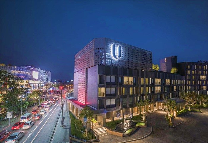 U Nimman Chiang Mai, a popular gay luxury hotel for gay travelers. Modern architecture at night, city view, and vibrant street scene.