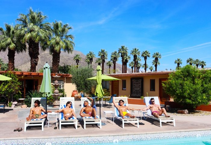 El Mirasol Villas, a gay men's resort in Palm Springs. Men lounge by the outdoor pool, enjoying the sun at this popular travel destination.