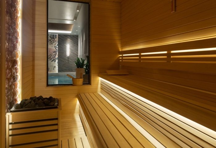 Gay sauna near Burdock Hotel Istanbul, Autograph Collection. Stylish wooden sauna with benches and rocks. A modern gay-friendly hotel amenity.
