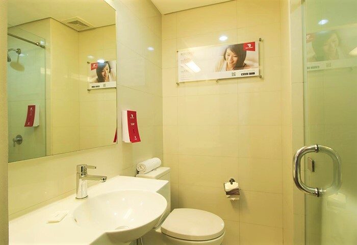 Red Planet Manila Makati hotel bathroom. Clean, modern design. LGBT-friendly hotel in Manila. Shower, sink, and toilet. Popular choice for gay travelers.