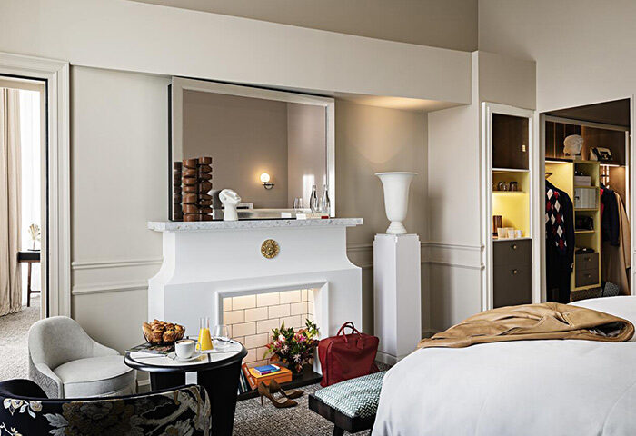 Sofitel Le Scribe Paris Opéra luxury hotel room. Fireplace, seating, and closet. Ideal for gay couples' romantic Paris vacation.